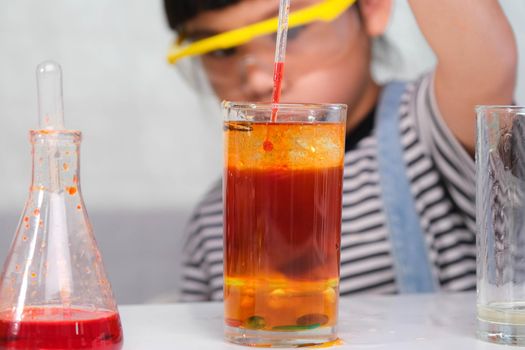 Children are learning and doing science experiments in the classroom. Little girl playing science experiment for home schooling. Easy and fun science experiments for kids at home.