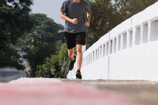 Young man runner feet running on the road be running for exercise. healthy exercise concept.