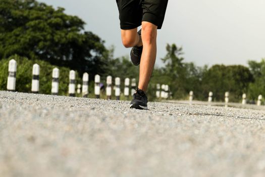 Young man runner feet running on the road be running for exercise. healthy exercise concept.