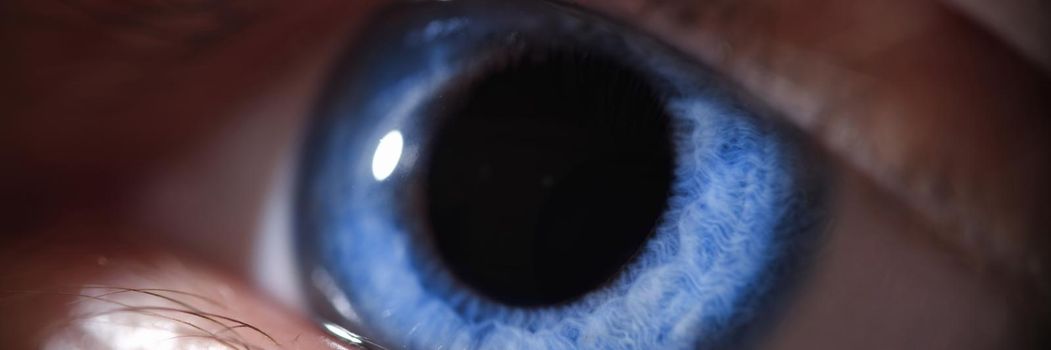 Closeup of beautiful bright blue human eye. Vision correction concept