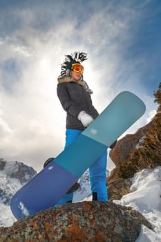 Young woman extreme snowboarder on freeride. Wintertime moments. Copy space