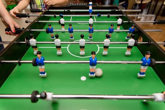 People playing in table football, foosball or kicker