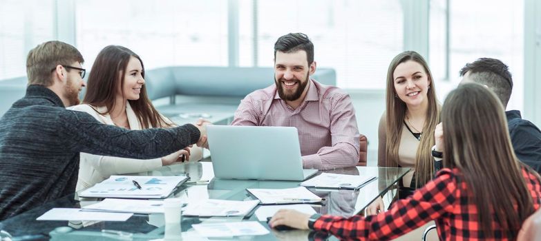 handshake financial partners and business team in the workplace in the office