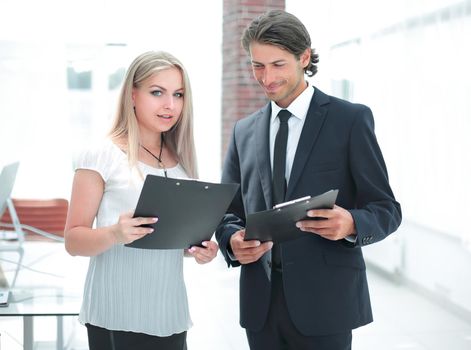 businessman and businesswoman discussing documents before the meeting .office life