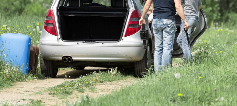 young married couple traveling by their car. stop on the road