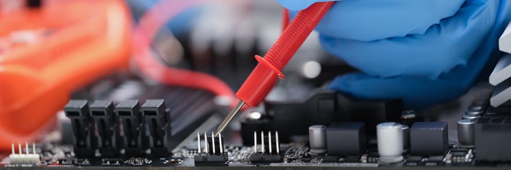 Soldering electronics microcircuits, hands close-up, blurry. Electrical and microelectronics courses, training