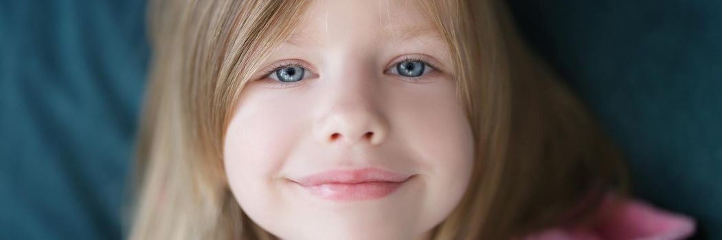 Smiling beautiful face of a little cute girl, close-up. European child, preschooler, happy childhood