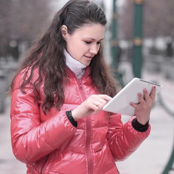 young woman with digital tablet on city background.