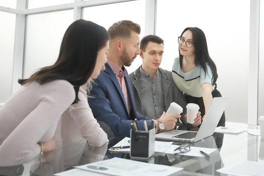 Manager pointing to laptop screen during working meeting . people and technology