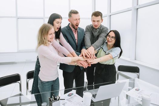 business team showing their unity by standing near the office Desk. the concept of teamwork