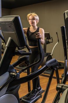 Elliptical trainer young sport person, In the afternoon fitness exercise for home girl classes, class elliptical. Cardio cycle living, trainer