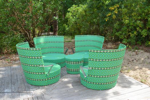 Comfortable green wicker chairs and table in a restaurant