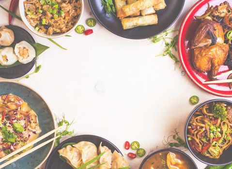 Chinese food white background. Chinese noodles, fried rice, dumplings, peking duck, dim sum, spring rolls. Famous Chinese cuisine dishes set. Space for text. Top view. Toned image