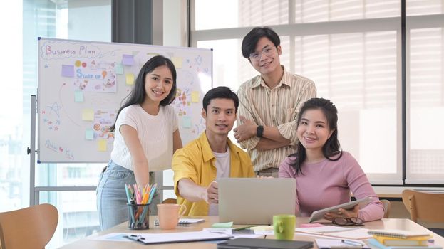 Successful business team gather in boardroom and smiling posing for camera.Teamwork concept.