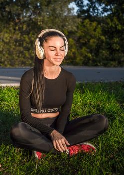 Nice girl outdoors with headphones./Athletic girl listening to music with headphones.