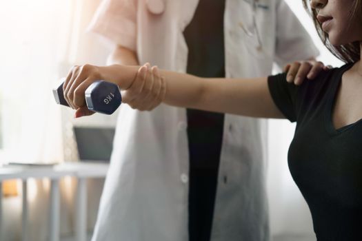 Cropped shot young woman doing exercises under physiotherapist supervision.