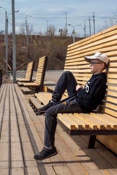 Portrait of happy child in glasses. Summer vacation concept. Smiling kid boy in hat and glasses near sea. Sustainable climate visuals