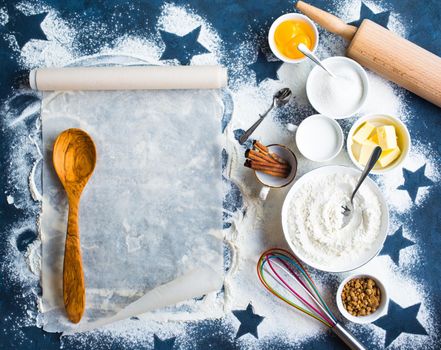 Baking background. Flour, sugar, eggs, butter, milk, cinnamon sticks, whisk, rolling pin, baking paper. Space for text. Ingredients for baking. Kitchen utensils. Top view. Making baked goods. Concept