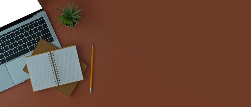 Laptop computer, coffee cup, plant and notebook on brown background with copy space.