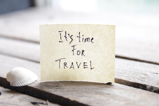 It's travel time concept. Paper card with an inscription. Summer Vacations idea.