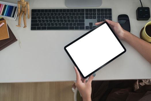 Above view woman hands holding digital tablet with white screen.