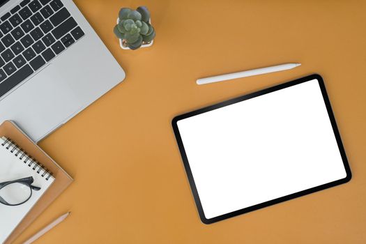 Mockup digital tablet, laptop and notebooks on yellow background. Blank screen for graphic display montage.