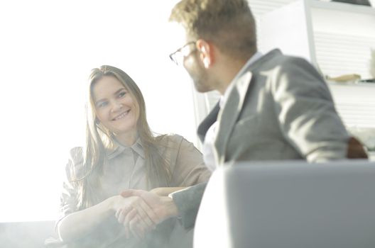 background image of a handshake of colleagues in the workplace.photo with copy space