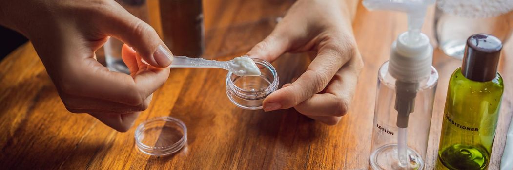 Travel kit for transporting cosmetics on an airplane. Cosmetics are ready to be poured into small bottles. A woman shifts cosmetics to take with her. BANNER, LONG FORMAT