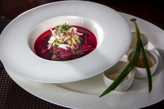 Cold borscht - speciality for hot days. Vegetable cold soup with beetroots. Shallow depth of field, selective focus.