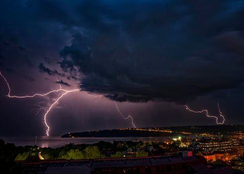 beautiful powerful lightning strikes over the sea and city, Varna. Bulgaria