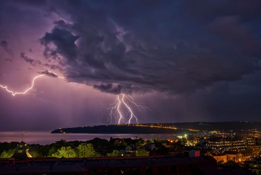 beautiful powerful lightning strikes over the sea and city, Varna. Bulgaria