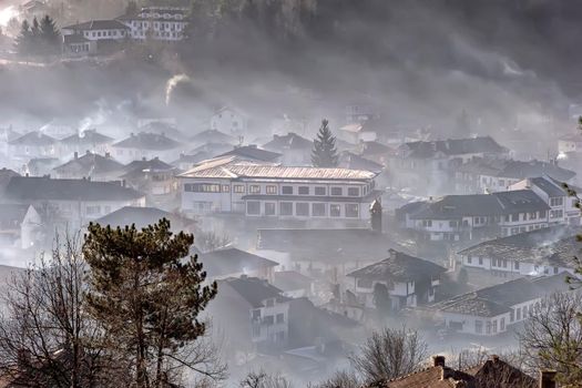 Colorful morning with fog and sun rising over an old mountain village