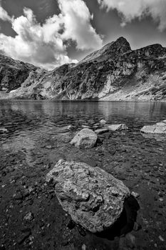 beauty black and white  landscape on the mountain lake with a big rock at the front