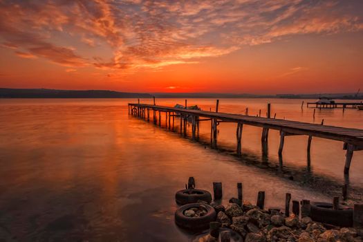 Stunning sunset at the harbour with wooden pier