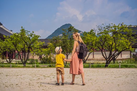 Mom and son tourists in Korea. Gyeongbokgung Palace grounds in Seoul, South Korea. Travel to Korea concept. Traveling with children concept.