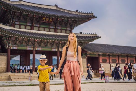 Mom and son tourists in Korea. Gyeongbokgung Palace grounds in Seoul, South Korea. Travel to Korea concept. Traveling with children concept.