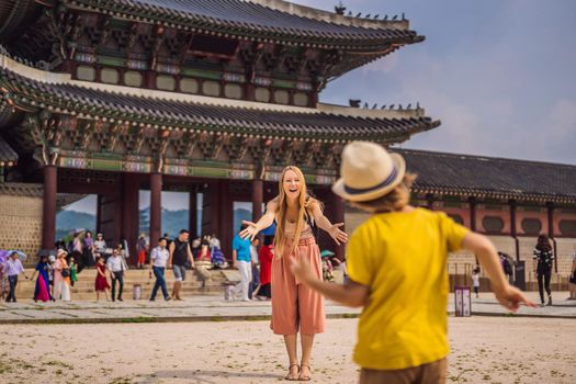 Mom and son tourists in Korea. Gyeongbokgung Palace grounds in Seoul, South Korea. Travel to Korea concept. Traveling with children concept.