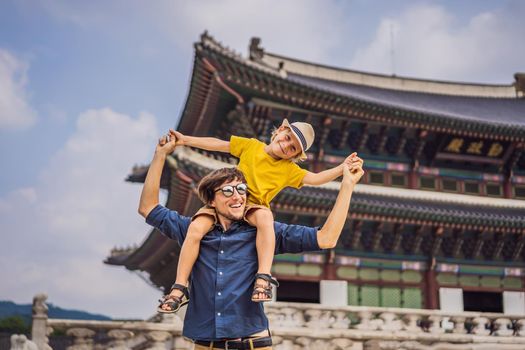 Dad and son tourists in Korea. Gyeongbokgung Palace grounds in Seoul, South Korea. Travel to Korea concept. Traveling with children concept.