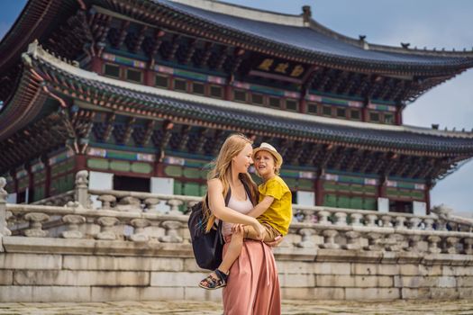 Mom and son tourists in Korea. Gyeongbokgung Palace grounds in Seoul, South Korea. Travel to Korea concept. Traveling with children concept.