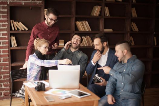 positive creative team of copywriters in the workplace in a modern office