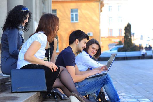 closeup. a group of students communicating via the Internet using laptop