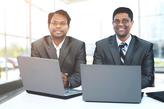 Interracial business team working at laptop in a modern office