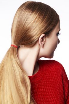 Woman with Straight Blond Hair, Tied in Ponytail, Wearing Red Knitted Pullover. Beautiful Gold Hair in Pony Tail. Fashion Style