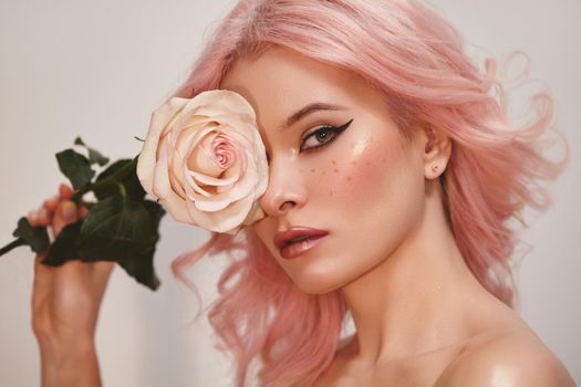 Soft-Girl Style with Trend Pink Flying Hair, Fashion Make-up. Woman Face with Fake Freckles, Blush Rouge and Rose Flowers. Valentines Day Look, Womens Day, March 8 or Freshness Spring Style