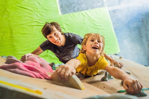 Dad and son at the climbing wall. Family sport, healthy lifestyle, happy family.