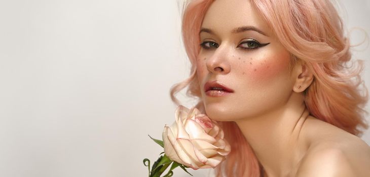 Beautiful woman with pink hair and fashion make-up. Blonde Female Model with perfect Fresh Clean Skin, Blush Rouge.