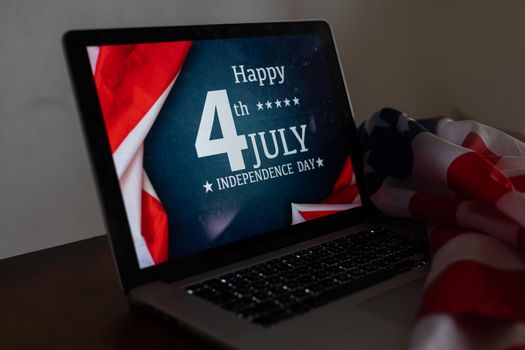 laptop with inscription 4 July inscription over american flag. Independence day
