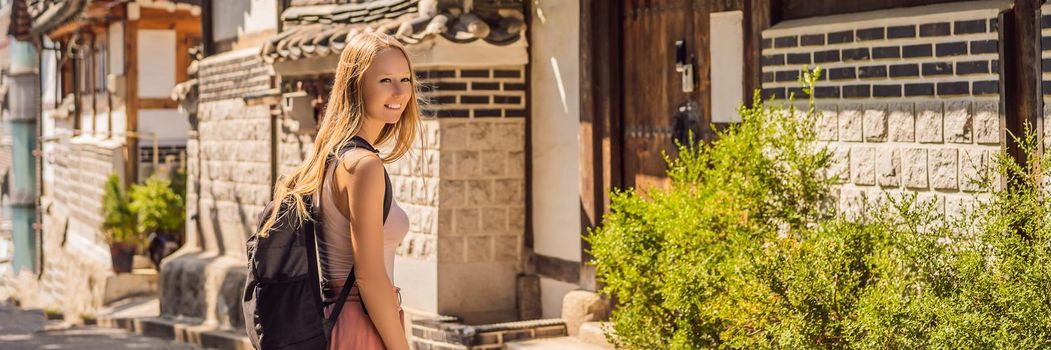 Young woman tourist in Bukchon Hanok Village is one of the famous place for Korean traditional houses have been preserved. Travel to Korea Concept. BANNER, LONG FORMAT