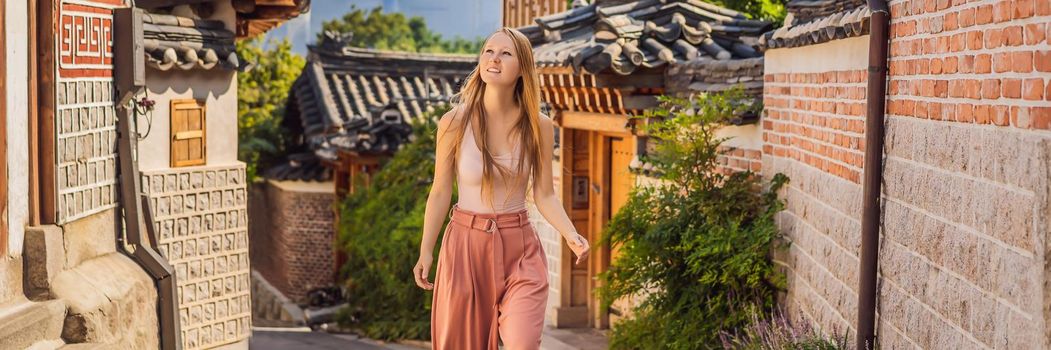 Young woman tourist in Bukchon Hanok Village is one of the famous place for Korean traditional houses have been preserved. Travel to Korea Concept. BANNER, LONG FORMAT