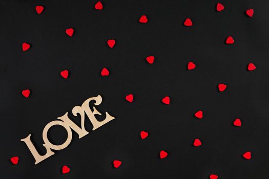 Valentines day background. Red hearts on the black desk. Top view. Copy space. Still life. Flat lay.